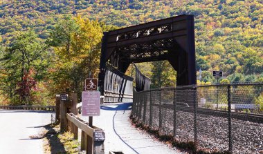 Jim Thorpe, Pennsylvania, U.S.A - October 19, 2024 - The metal bridge and bike trail at Lehigh Gorge State Park clipart