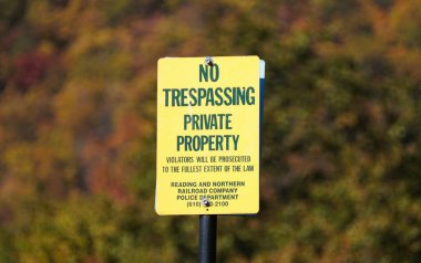 Jim Thorpe, Pennsylvania, U.S.A - October 19, 2024 - The 'No Trespassing Private Property' sign on the train track by Reading and Northern Railroad Company clipart