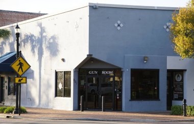 Winter Haven, Florida, U.S.A - November 10, 2024 - A corner storefront, painted a muted gray-blue, displaying the sign 