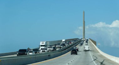 St Petersburg, Florida, U.S - Nov 12, 2024 - The traffic on on Bob Graham Sunshine Skyway Bridge on the sunny day clipart