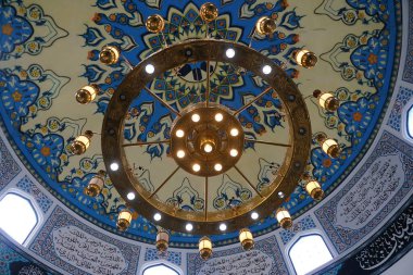 Pangkor Island, Perak, Malaysia - January 20, 2025 - Beautiful dome interior with blue and cream tiles and ceiling lights inside of the Al-Badr Mosque clipart