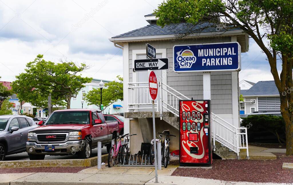 Ocean City, Maryland, U.S.A - May 23, 2025 - A municipal parking lot, marked with clear signage and vending machine, provides convenient parking options for visitors.