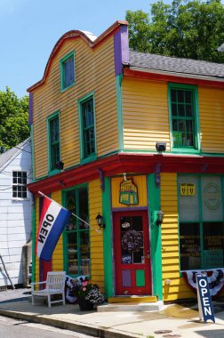 St Michaels, Maryland, ABD - 30 Haziran 2025 - neşeli renklerle boyanmış canlı bir köşedeki dükkan, açık tabelalı müşterileri karşılıyor.