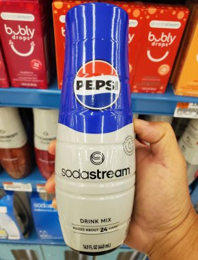 Delaware, U.S.A - Sept 30, 2025 - A close-up view of the SodaStream Pepsi Drink Mix bottle, held in hand, showing the branding and yield of approximately 24 cans.