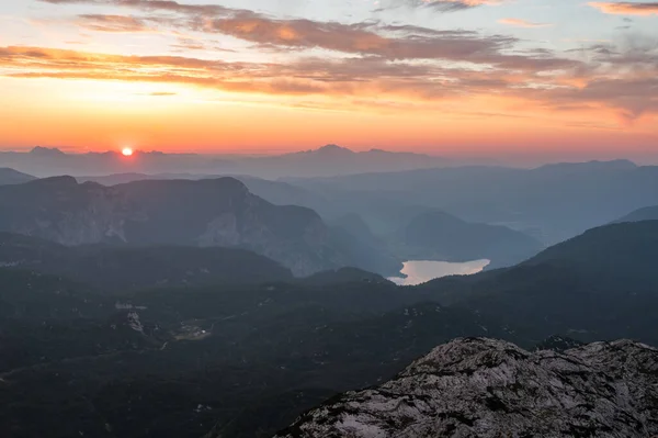 Spectacular sunrise with sun rising above lake Bled as seen from the mountains. Komna, Slovenia.