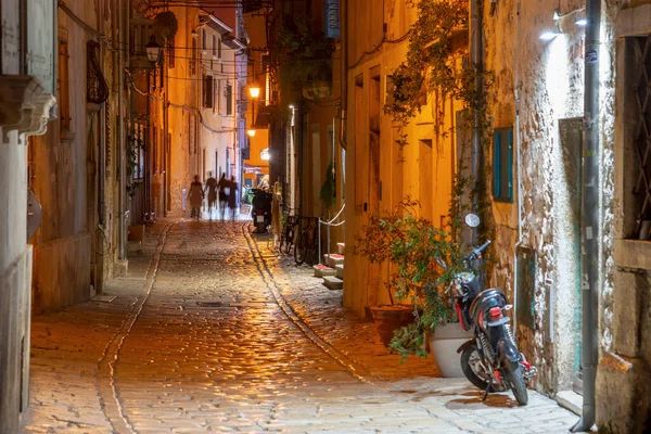 Stock image Cobbled street with old houses details by night in Rovinj old town, Croatia