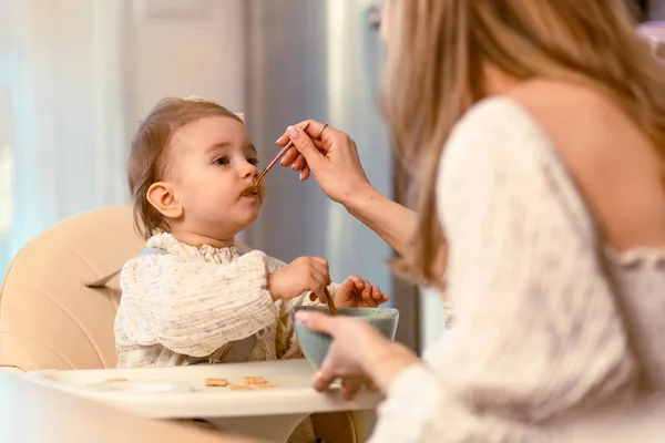 Young Mom Feeding Her Baby Daughter Spoon — Stock Photo, Image