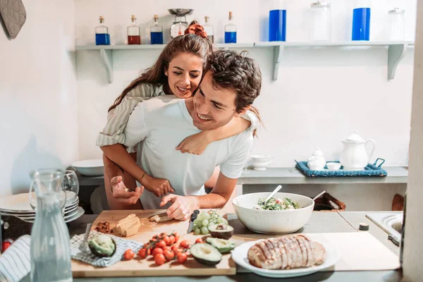 Young couple having fun in the kitchen in the morning, while preparing breakfast