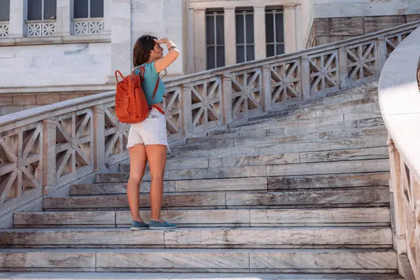 stock image Young brunette female tourist standing on the stars in Athens, Greece
