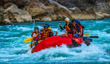 Young persons rafting on the river Ganges in Rishikesh India, extreme and fun sport at tourist attraction