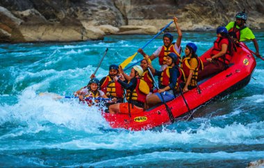 Young persons rafting on the river Ganges in Rishikesh India, extreme and fun sport at tourist attraction