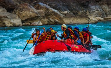Young persons rafting on the river Ganges in Rishikesh India, extreme and fun sport at tourist attraction