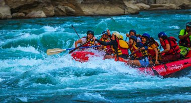Young persons rafting on the river Ganges in Rishikesh India, extreme and fun sport at tourist attraction