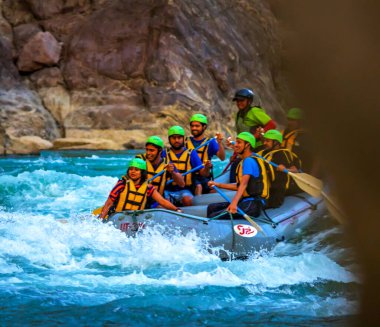 Young persons rafting on the river Ganges in Rishikesh India, extreme and fun sport at tourist attraction