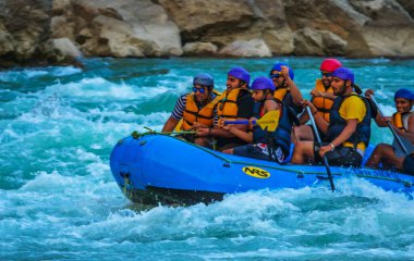 Young persons rafting on the river Ganges in Rishikesh India, extreme and fun sport at tourist attraction