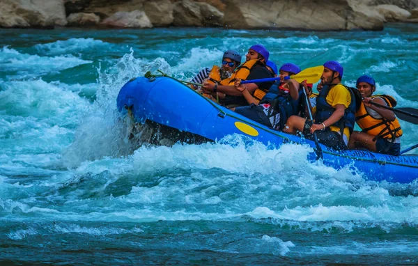 Young persons rafting on the river Ganges in Rishikesh India, extreme and fun sport at tourist attraction