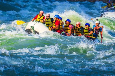 İnsanlar Rishikesh Hindistan 'da Ganj nehrinde rafting yaparken eğleniyorlar.