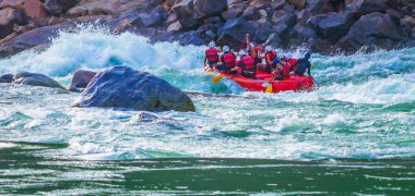 İnsanlar Rishikesh Hindistan 'da Ganj nehrinde rafting yaparken eğleniyorlar.