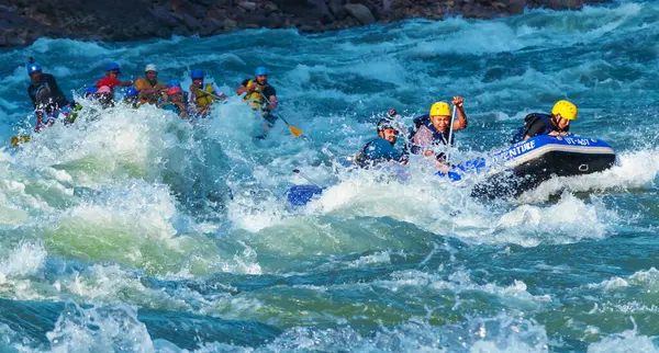 İnsanlar Rishikesh Hindistan 'da Ganj nehrinde rafting yaparken eğleniyorlar.