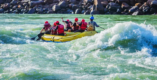 İnsanlar Rishikesh Hindistan 'da Ganj nehrinde rafting yaparken eğleniyorlar.