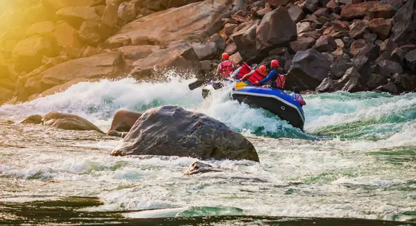 İnsanlar Rishikesh Hindistan 'da Ganj nehrinde rafting yaparken eğleniyorlar.