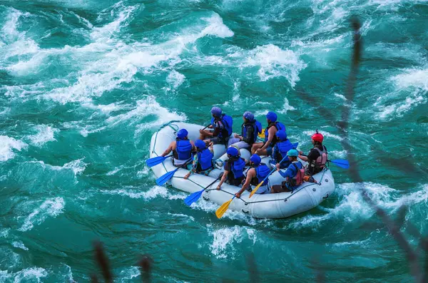 İnsanlar Rishikesh Hindistan 'da Ganj nehrinde rafting yaparken eğleniyorlar.
