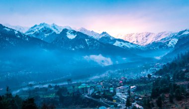 Himalayalar 'ın güzel manzarası ve Himachal Hindistan' da günbatımında bulutlarla kaplı Manali şehri.