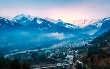 Himalayalar 'ın güzel manzarası ve Himachal Hindistan' da günbatımında bulutlarla kaplı Manali şehri.
