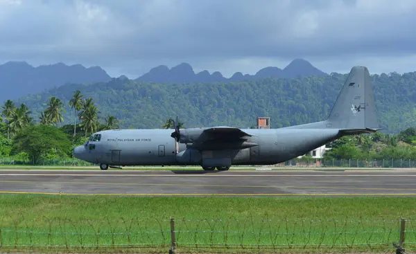 stock image Langkawi, Malaysia - May 28, 2023. Lockheed C-130H-30 Hercules M30-12 TUDM of Royal Malaysian Air Force taxiing for takeoff from Langkawi Airport (LGK), Malaysia.