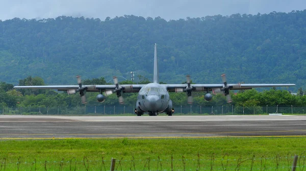 stock image Langkawi, Malaysia - May 28, 2023. Lockheed C-130H-30 Hercules M30-16 TUDM of Royal Malaysian Air Force taxiing for take off from Langkawi Airport (LGK), Malaysia.