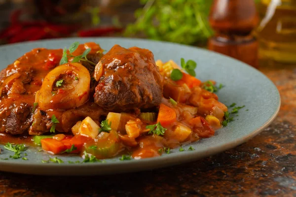 Ossobuco Served Stewed Vegetables Colorful Background Grey Plate — стоковое фото