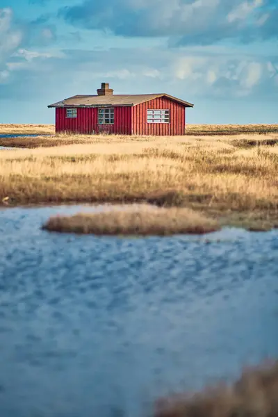 Red Cabin in danish landscape. High quality photo
