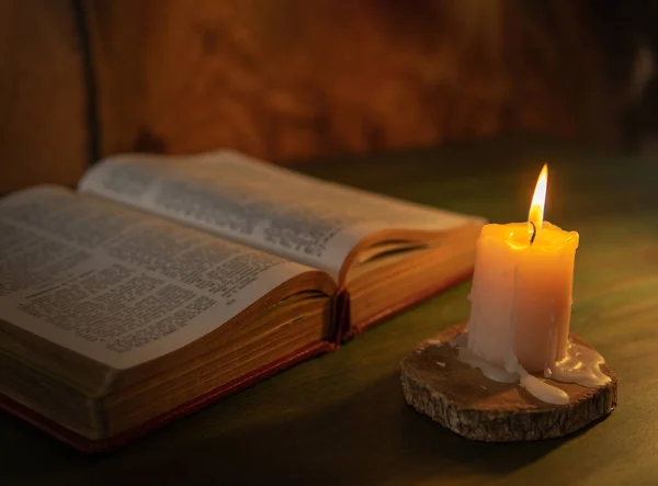 bible lit with a candle religion and message concept