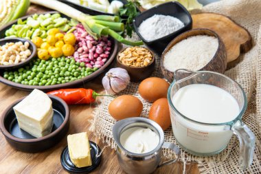 Close-up of legumes, eggs and dairy on a rustic background