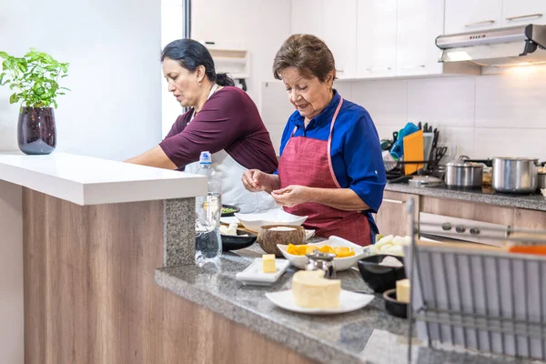 Two women of different generations cooking. High quality photo