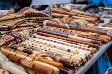kenas and Andean flutes at a poncho market stall in Otavalo Ecuador. High quality photo clipart