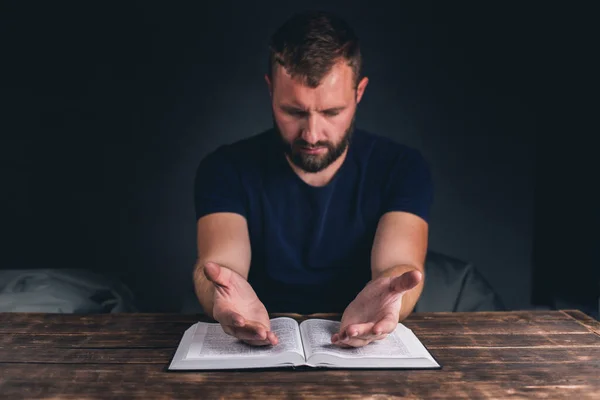 Man Prays Folded Hands Open Holy Bible Table Young Man — Stock Photo, Image