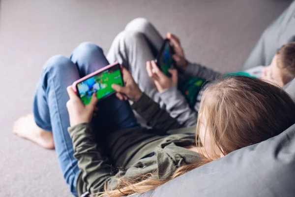 stock image Children play video games. Children with a phone in their hands. Addiction to the phone
