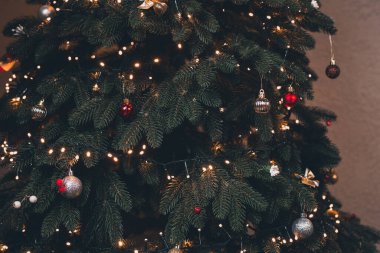 Noel ağacı oyuncaklar ve çelenklerle süslenmiştir. Yılbaşı arifesinde çelenkler.