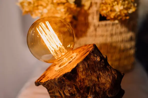 Table lamp made of wood. Edison electric lamp. Incandescent lamp. Autumn
