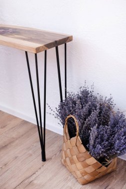 Tahta sehpa konsolu. Çatı katı tarzında bir masa. Ceviz ağacı gövdesi ve kurumuş çiçeklerden yapılmış bir masa. Epoksi reçine. Bir sepet dolusu lavanta çiçeği.