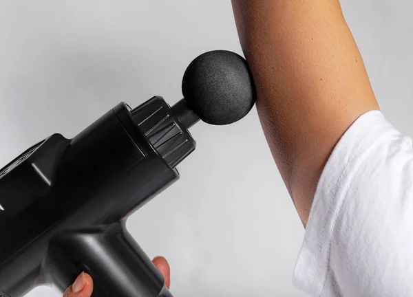 Massage gun on different body parts. Handheld cordless professional percussion deep tissue body muscle fascia massager for athletes isolated on white background.