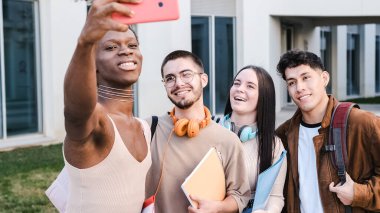 transgender persona and a multiethnic group of friends taking a selfie outside the university