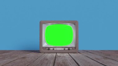 Real time zoom in of old fashioned vintage brown television with green screen for chroma placed on wooden floor against blue background