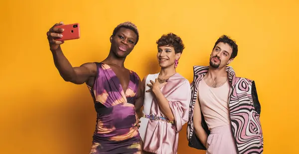 three multiethnic transgender men taking a selfie in a photographic studio