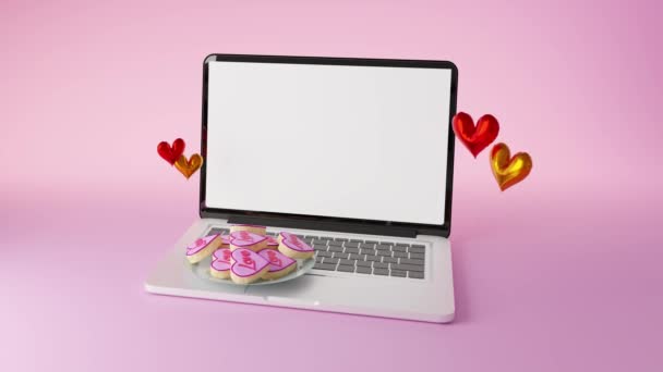 Animação Biscoito Forma Coração Colocado Laptop Contra Superfície Rosa Clara — Vídeo de Stock