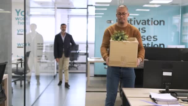 Mixed Race Young Businessman Carrying Cardboard Box Leaves Creative Workspace — Stock Video