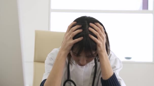Stressed Young Female Doctor Sitting Head Hands She Suffers Headache — Stock Video
