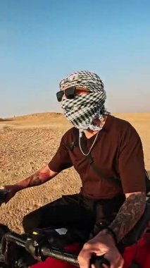 Çölde tek başına gezen gezginlerin avludaki kumlu arazide gezdiği geleneksel keffiyeh giyerek güneşli, ortadoğu manzarasını keşfettiği bir macera.