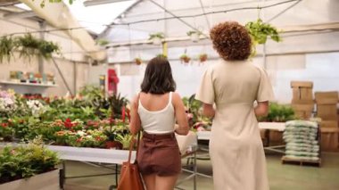 Ev sahibi kadın müşteriye renkli bebek odasında rehberlik ediyor.